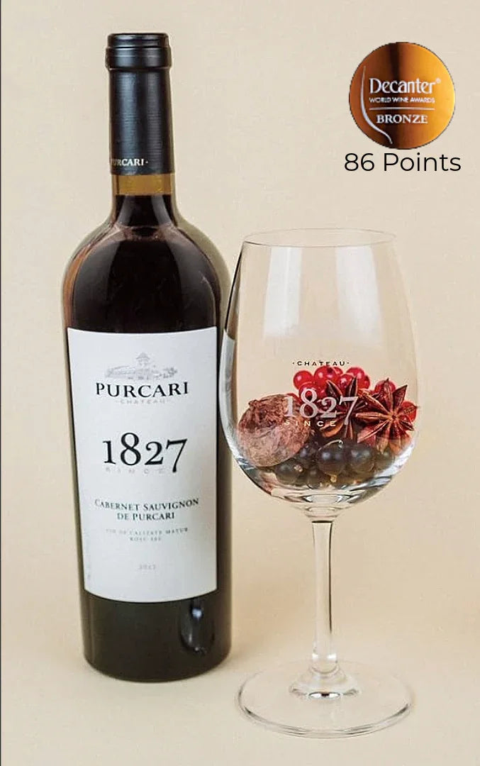 Purcari Cabernet Sauvignon 1827 wine bottle with a filled glass and Decanter bronze award badge