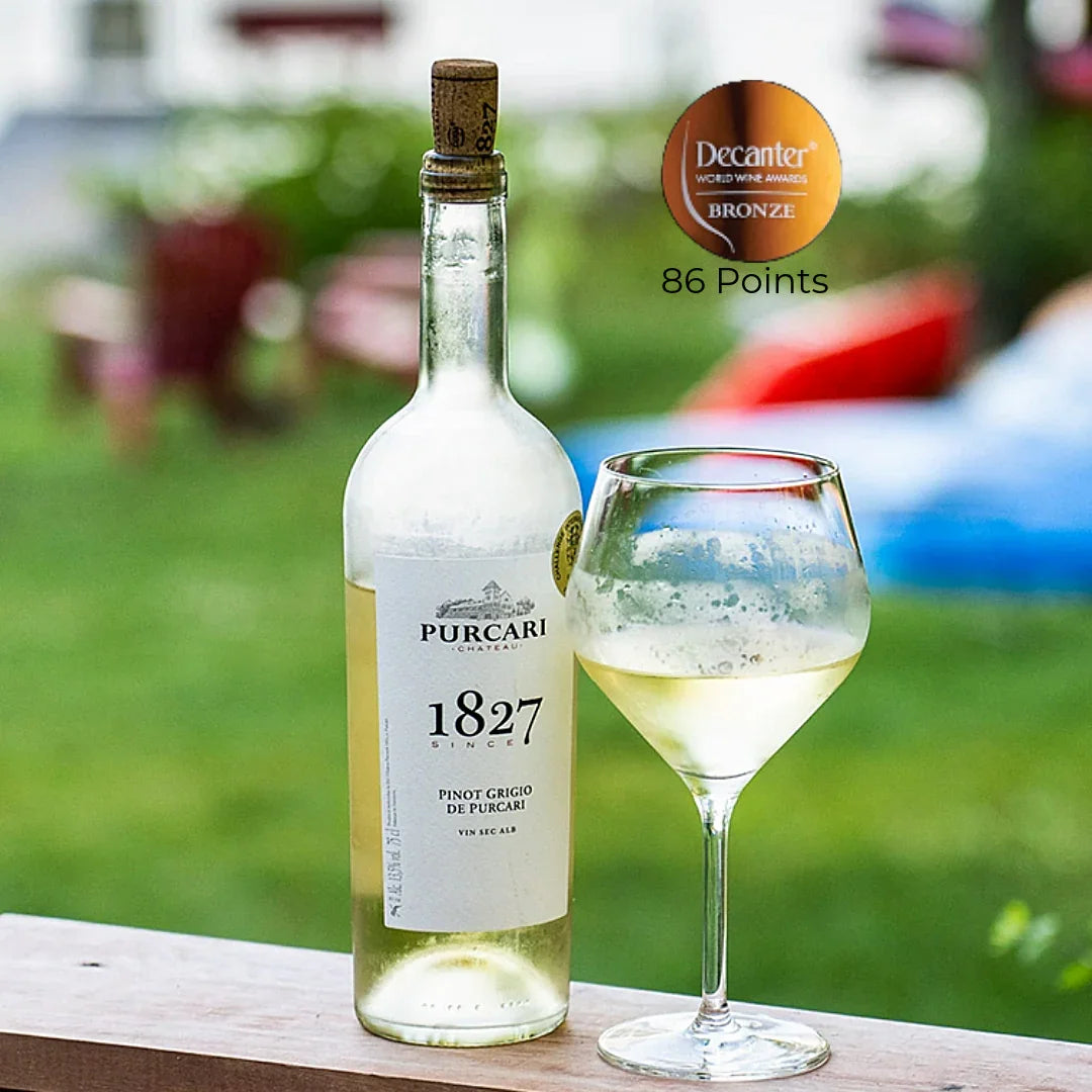Chilled bottle of Purcari 1827 Pinot Grigio wine and glass on outdoor table, Decanter bronze award.