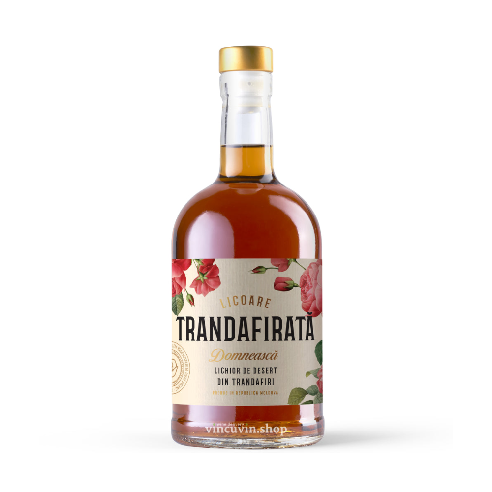 A bottle of Trandafirata Domnească liqueur de desert, featuring an amber-brown liquid inside a clear glass bottle with a gold cap and a cream-colored label decorated with red roses, set against a plain white background.