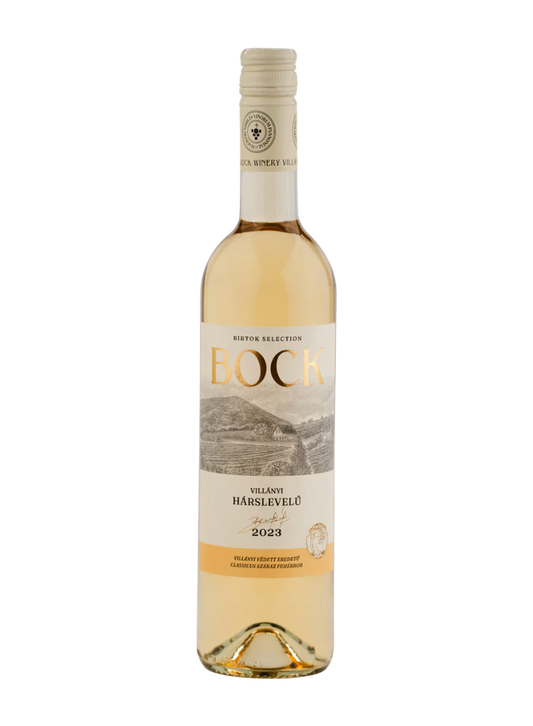 A bottle of Bock Villány Hárslevelül white wine, showing the pale golden liquid inside a clear glass bottle with a cream-colored label and gold foil at the neck, set against a plain white background.