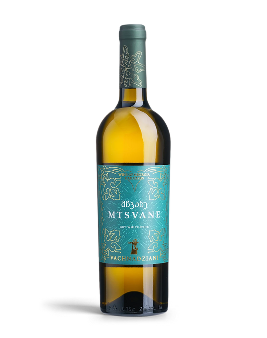 A bottle of Mtsvane dry white wine by Vachevadzi, featuring a teal label with gold foil patterns and a dark green capsule, set against a plain white background.